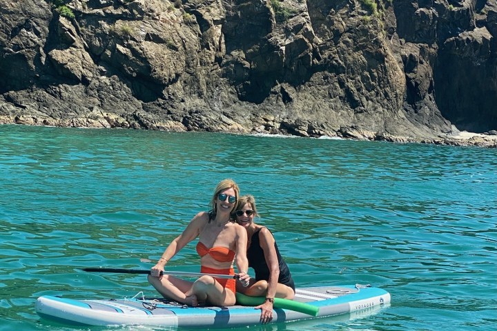 a man riding a surfboard on top of a mountain