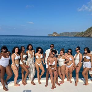a group of people on a beach posing for the camera