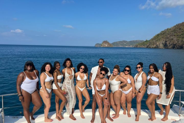a group of people on a beach posing for the camera