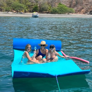a group of people sitting in a boat on a body of water