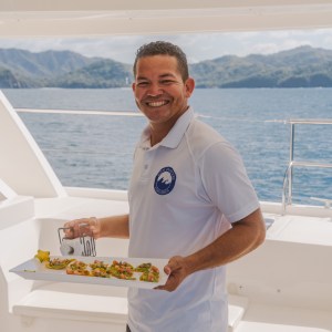 a man standing next to a body of water