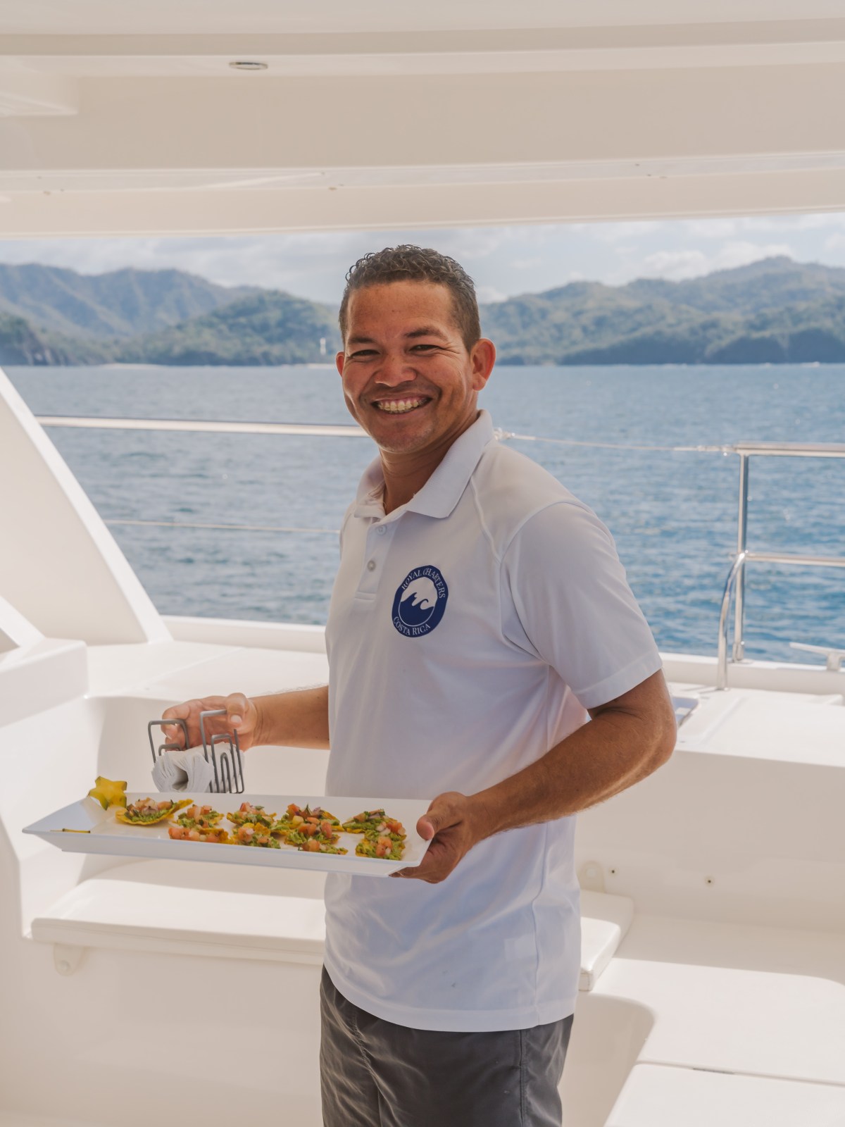 a man standing next to a body of water