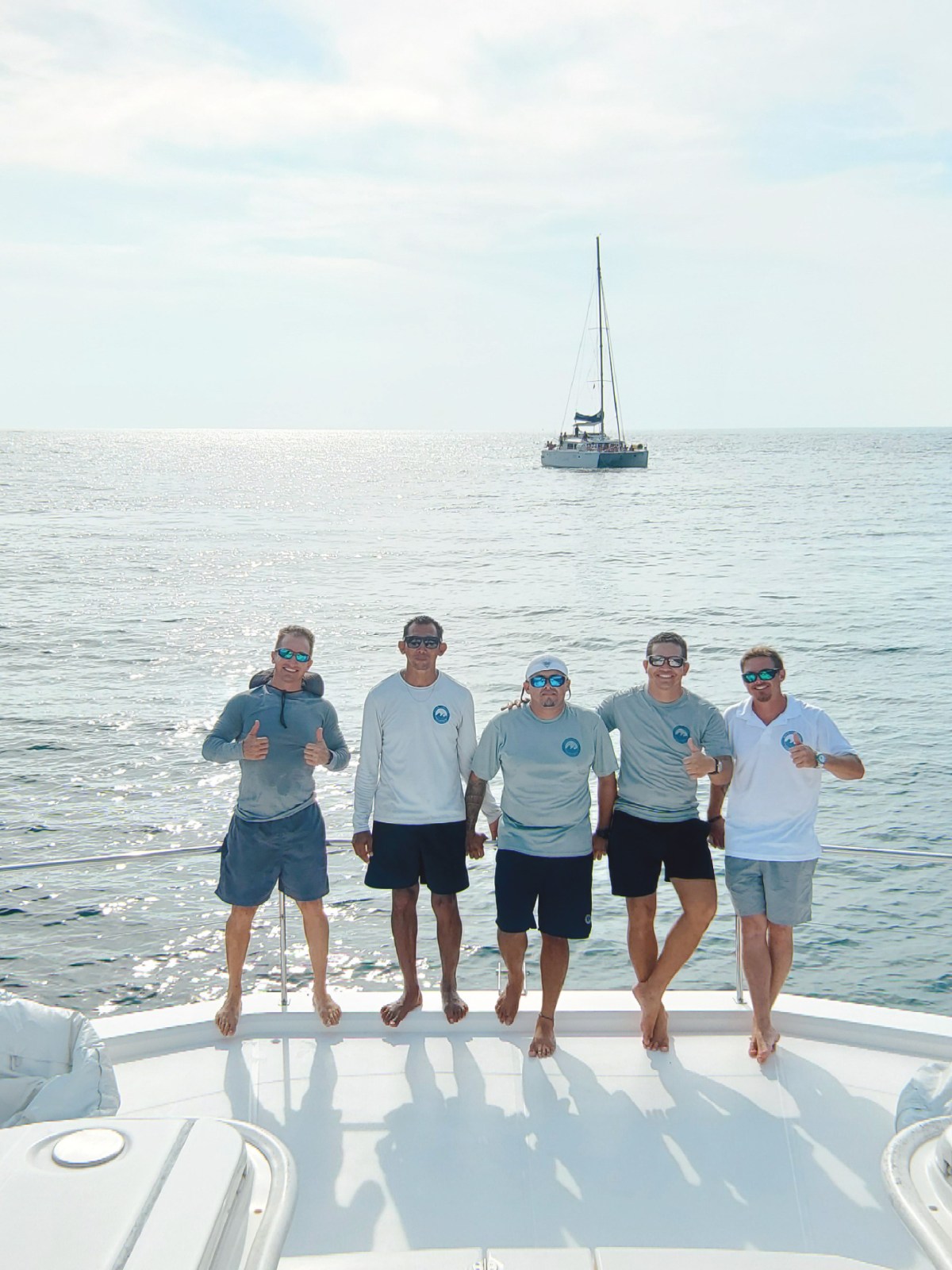 a group of people on a boat posing for the camera