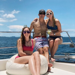 a man and woman sitting next to a body of water