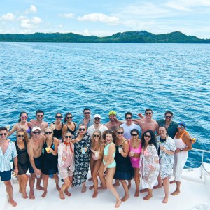 a group of people standing next to a body of water