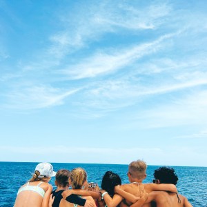 a group of people sitting at a beach