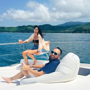 a woman sitting next to a body of water