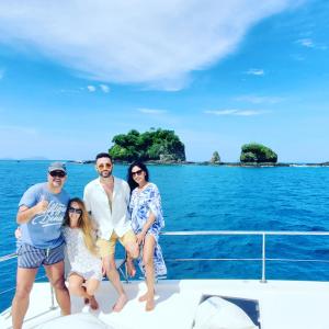 a group of people standing next to a body of water