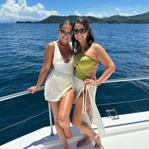 a woman standing next to a body of water